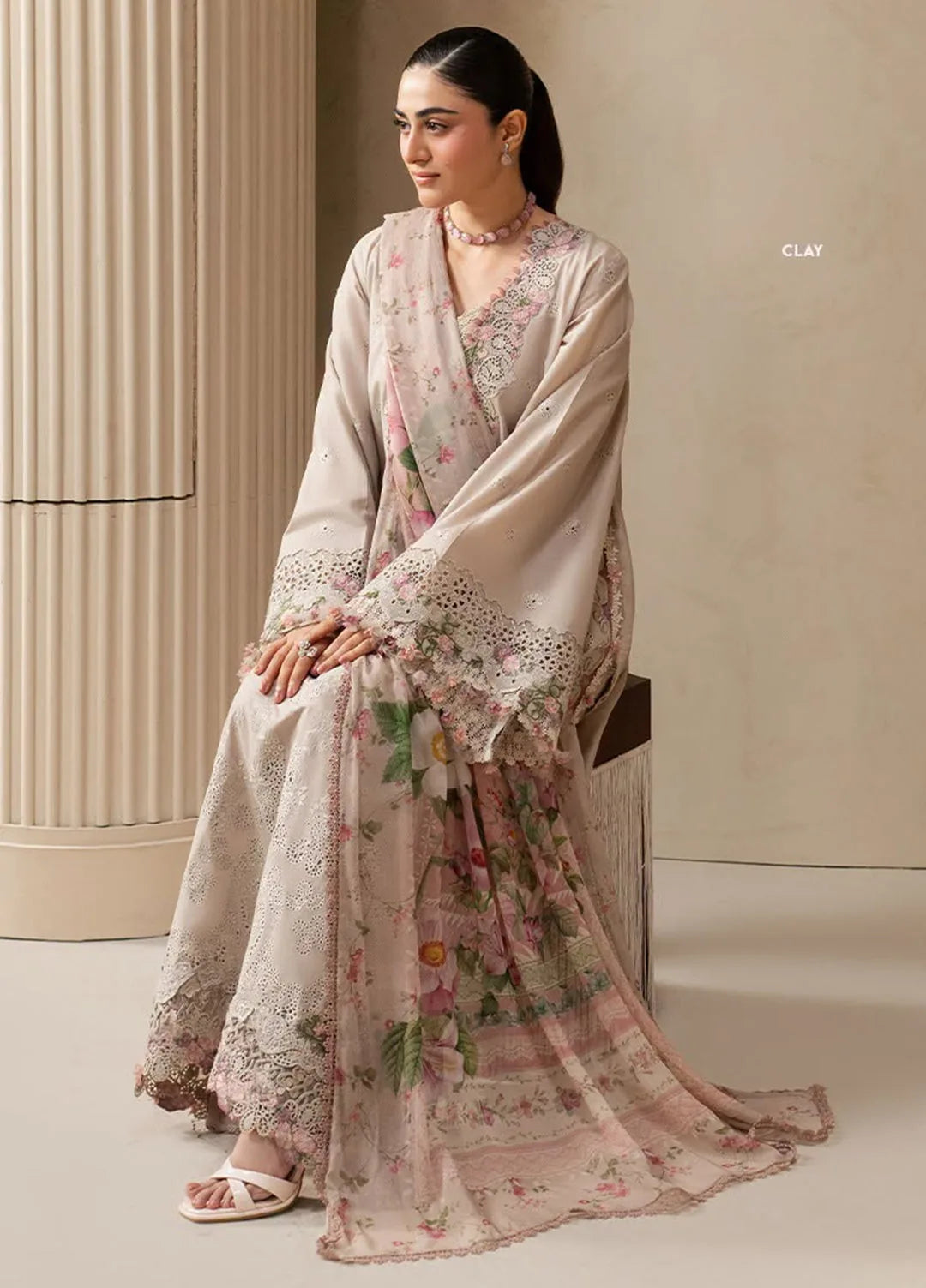 Clay beige Dhanak unstitched dress shown styled with a pink floral dupatta, seated view
