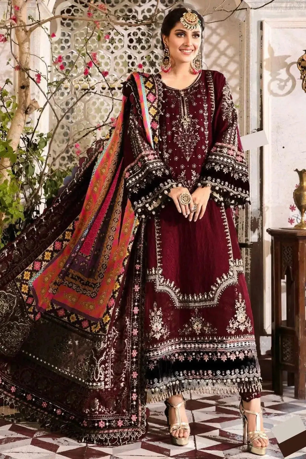 Maroon Dhanak dress showing ivory floral neckline embroidery, black sleeve borders and multicolour shawl detail
